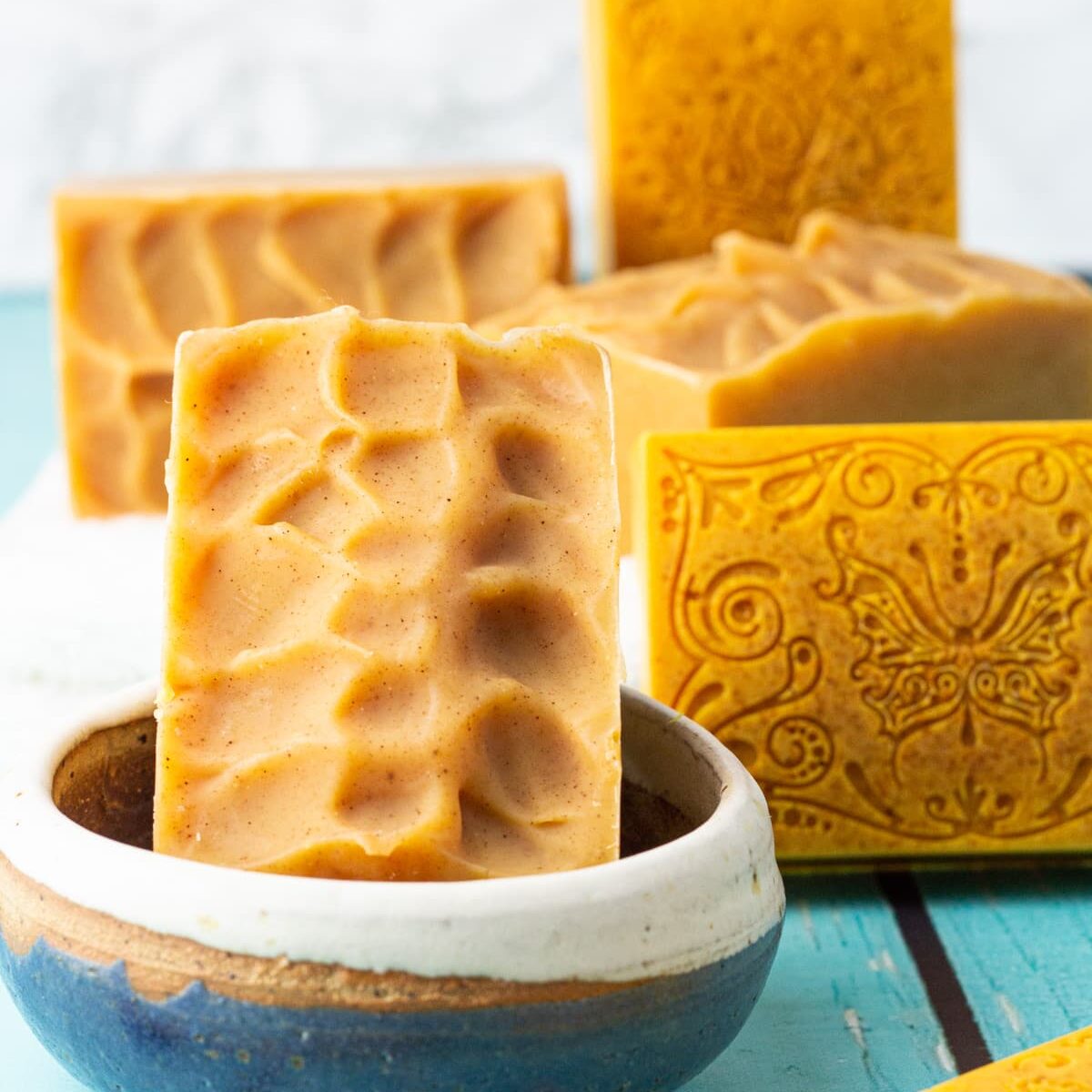 cold process turmeric soap in soap dish.