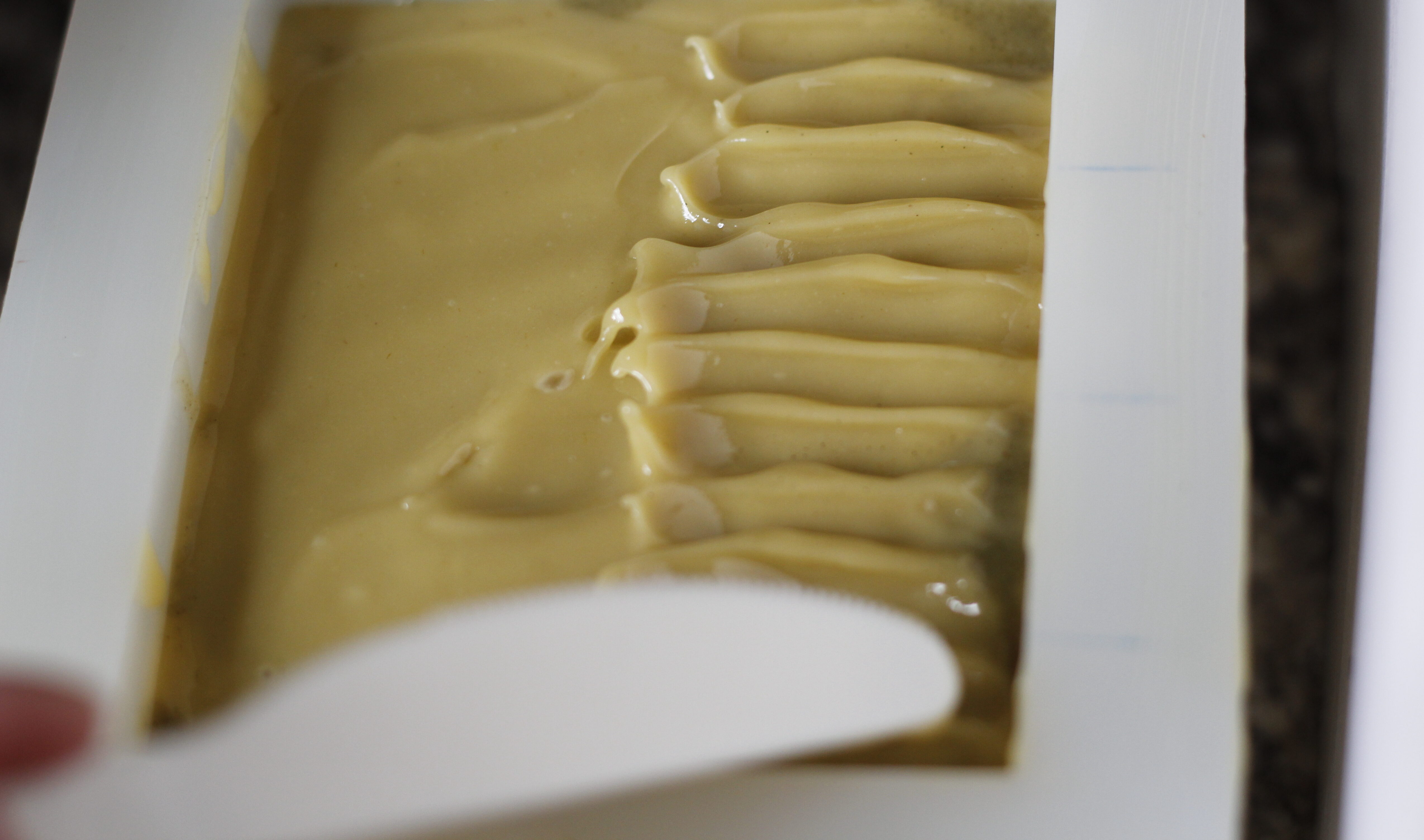 decorating top of soap using knife.