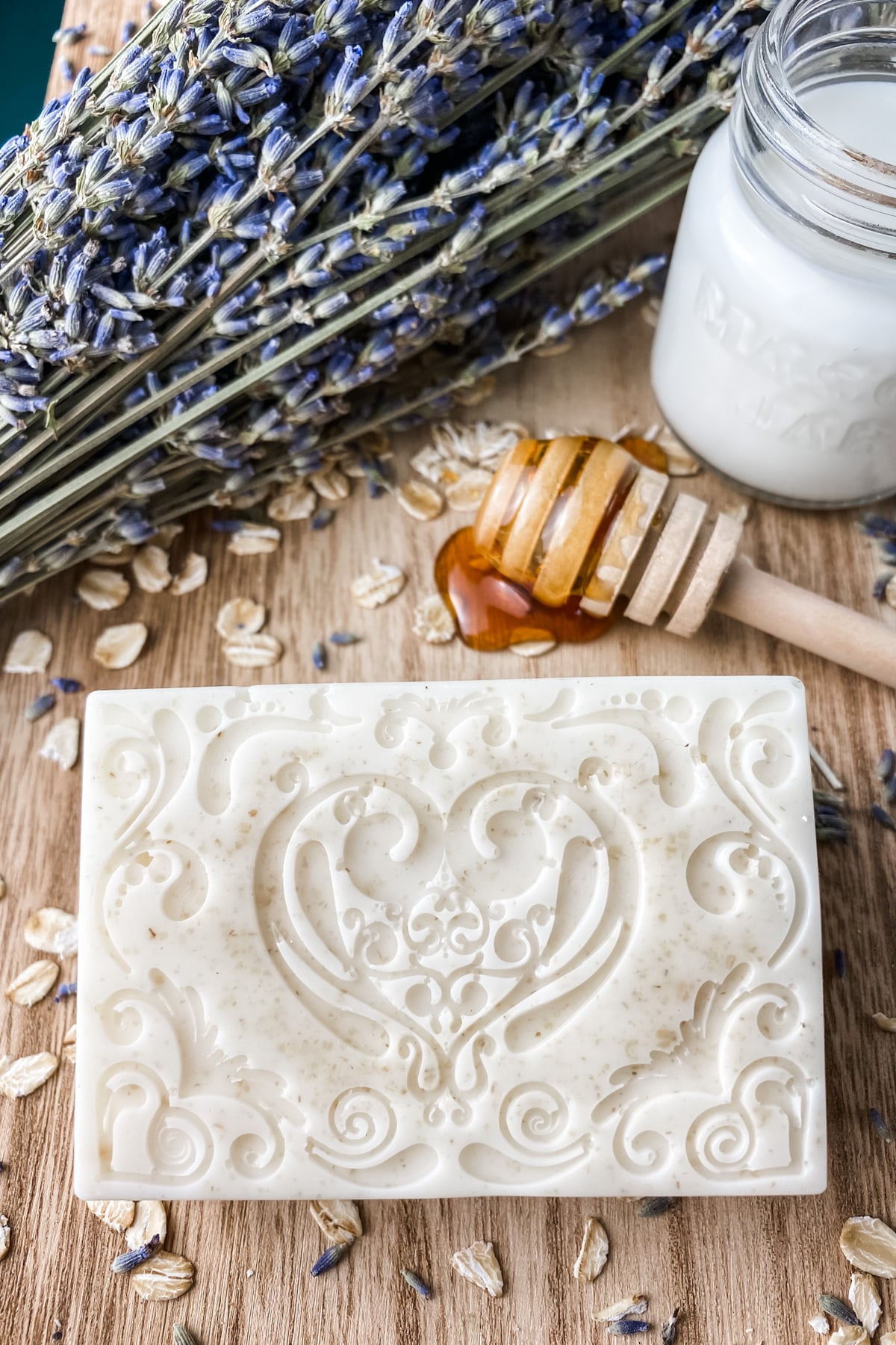 bar of goat milk soap with oatmeal, real honey and a glass of milk.