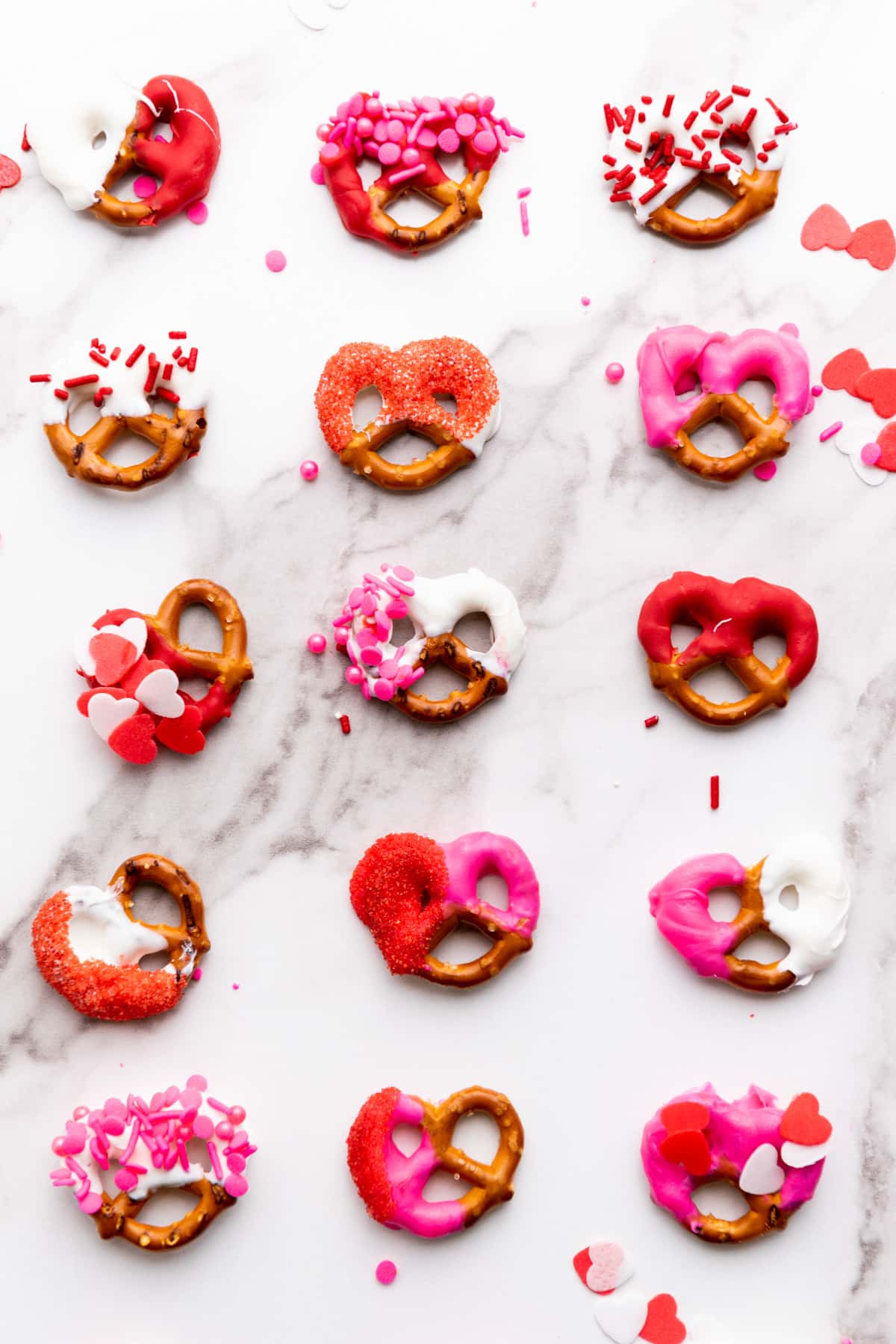 decorated pretzels in rows on table.