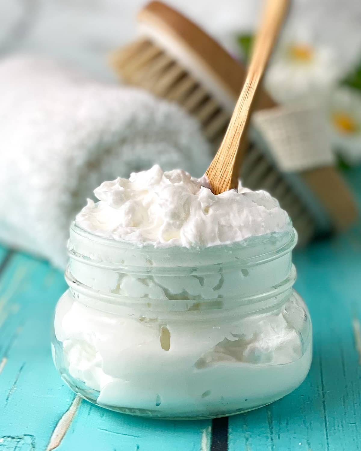body butter in jar with spoon.